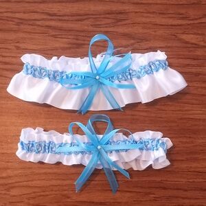 Wedding garter set. White satin with blue paisley center. Approx 15 to 26 inches